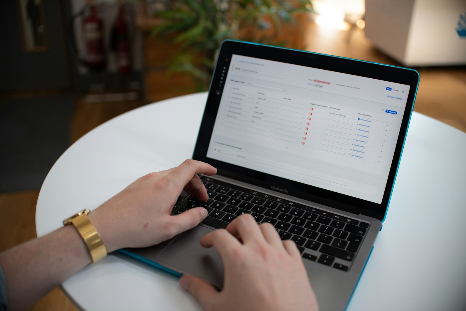 Hands typing on a laptop with a spreadsheet, representing AI-automated data entry